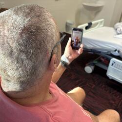 Patient Mark Geddes has a remote consultation with Epworth neurologist Dr Mina Ghaly