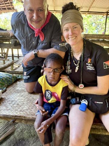 Meaghan Acreman with a young boy who needed a makeshift glasses repair