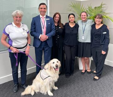 Julie Quinn and her dog Charlie meet CEO Andrew Spillane and team members from Westmead Private Hospital